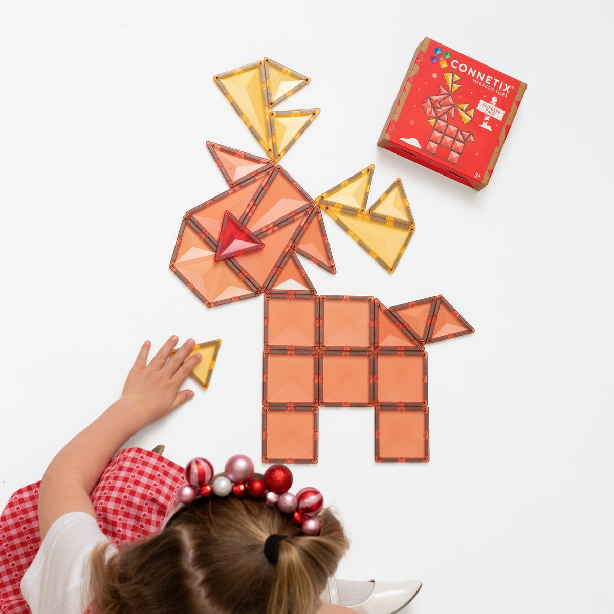 Child building a reindeer with Connetix tiles