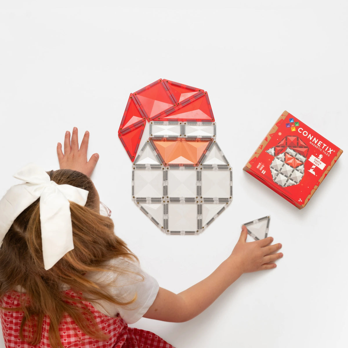 Child building a Santa with Connetix magnetic tiles